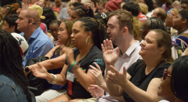 A group of blind people clapping.